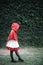 Portrait young woman with Little Red Riding Hood costume in green tree park