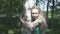 Portrait of the young woman with a long fair hair of the birch embracing a trunk in the birch wood