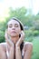 Portrait of young woman mediating in park