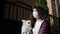 Portrait of young woman in medical mask and her dog Chihuahua walks on street during pandemic corona virus
