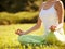 Portrait of young woman meditating in pose of lotus. Yoga background