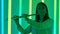 Portrait of young woman musician blowing into wind instrument flute. A female flutist performs in a dark studio against