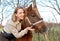 Portrait of a young woman next to a pony of Shetland breed