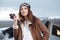 Portrait of young woman pilot in front of airplane.