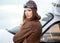 Portrait of young woman pilot in front of airplane.