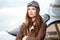 Portrait of young woman pilot in front of airplane.