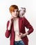 Portrait of young woman and playful Canadian Sphynx Cat sitting on her shoulder on white background