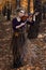 Portrait of young woman playing violin in the fall park