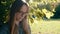 Portrait of a young woman relaxing in the shade of the tree. Copy space