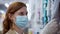 Portrait of young woman shopper in medical mask and gloves for protection against coronavirus in public place, caring