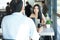 Portrait young woman sitting opposite a man ,couple of colleagues man and woman working by using laptops in coffee shop