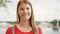 Portrait of young woman standing on waterfront in Paris. Young lonely tourist travelling in Europe