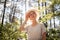 Portrait of a young woman in a straw hat, wiping sweat from her forehead. Summer. The concept of protection from