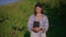 portrait of young woman with tablet in fruit garden, agronomist or scientist botanist