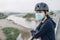 Portrait of young woman wearing a mask while riding a bicycle outdoor for protect and prevent the spread of virus.