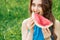 Portrait of a young woman what is eating watermelon. Copy space.