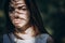 Portrait of a young woman in the woods, on the face shadow of ferns