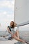 Portrait of a young woman on a yacht in the middle of the sea in summer