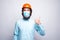 Portrait of young worker architect wearing medicinal mask and showing thumbs up