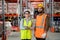 Portrait of young workers standing at storeroom