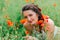 Portraite of beautiful girl in the poppy field