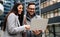 Portraite of handsome man and beautiful woman as business partners working talking outdoor