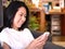 Portraits of Asian woman looking to her white smartphone.