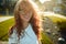 Portraits of a charming red-haired girl with a cute face. Girl posing for the camera in the city center. She has a wonderful mood