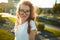 Portraits of a charming red-haired girl with a cute face. Girl posing for the camera in the city center. She has a wonderful mood