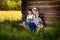 Portraits of friends, sitting near the wooden wall of the shed