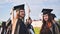 Portraits of graduating girls in black robes on the street.