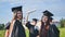 Portraits of graduating girls in black robes on the street.