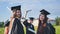 Portraits of graduating girls in black robes on the street.