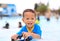 Portraits of happy little Asian baby boy smiling having fun at swimming pool outdoor