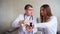 Portraits of intelligent male doctor, who explains girl to patient how to use smart Watch to monitor their health and