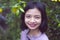 Portraits smiling Asian young girl with pine tree in vintage color