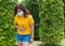 Portraits of women wearing protective masks During travel With a background of green trees