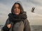 Portraits young attractive girl on the background of the sea, sky and gulls