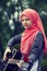 Portreit of preaty muslim girl trying to play guitar