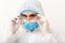 Portret of man doctor wearing googles, protective glusses in protection suit, face surgical mask on white background. Concept of