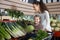 portret of young woman with beautiful daughter choosing green vegetables