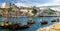 Portugal, city landscape Porto, a group of yellow wooden boats with wine port barrels on Douro river