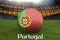 Portugal football team ball on big stadium background. Portugal Team competition concept. Portugal flag on ball team tournament in