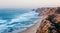 PORTUGAL, Praia do Magoito - Magoito Beach viewed from above. Magoito view with big vawes and misty, foggy air in September.