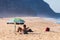Portugal, Praia Santa Rita Norte, October 04, 2018: People relaxing on sand beach under sun umbrellas