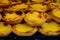 Portugal`s traditional sweet dessert Pastel de nata egg custard tart pastry served with view on display in bakery, Lisbon area,