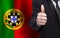 Portugese concept. Businessman showing thumb up on the background of flag of Portugal
