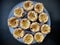 Portugese pastries - pasteis de nata on a glass plate. Delicious home made cuisine that is typical for the Lisbon region