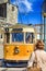 Portugese Travel Destinations. Woman Standing in Front of Traditional Porto Yellow Tram on Streets in Portugal