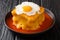 Portuguese delicious Francesinha sandwich with meat sausages, melted cheese, drizzled with tomato beer sauce and topped with a